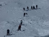 looking down the headwall at team mates on their way up